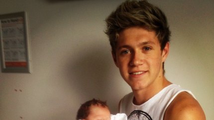 One direction holding baby 3