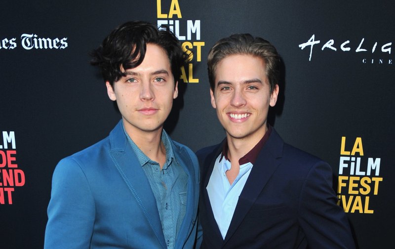 Dylan and Cole Sprouse wearing suits